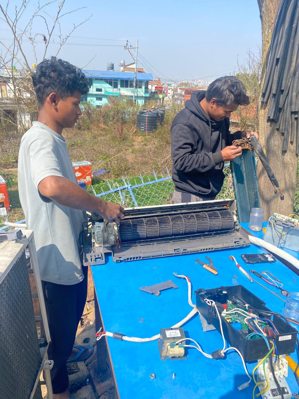 Technicians working on AC